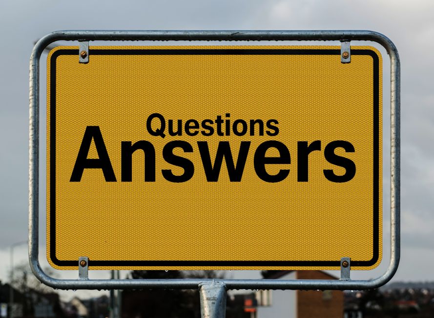 A large rectangular road sign with a yellow reflective background and a black border, mounted on a metal frame with visible bolts. The sign displays the word 'Questions' in smaller black letters above the word 'Answers,' which is written in bold, prominent black font. The sign is positioned outdoors against a cloudy sky, with a blurred urban background showing distant buildings and trees. The scene suggests a public information or guidance message, which may relate to accessible or alternative ways of resolving inquiries, indirectly supporting the context of rubbish removal services such as those offered by [COMPANY_NAME], especially in relation to private waste handling or independent collection options in areas facing access challenges on West End Lane or similar locations.